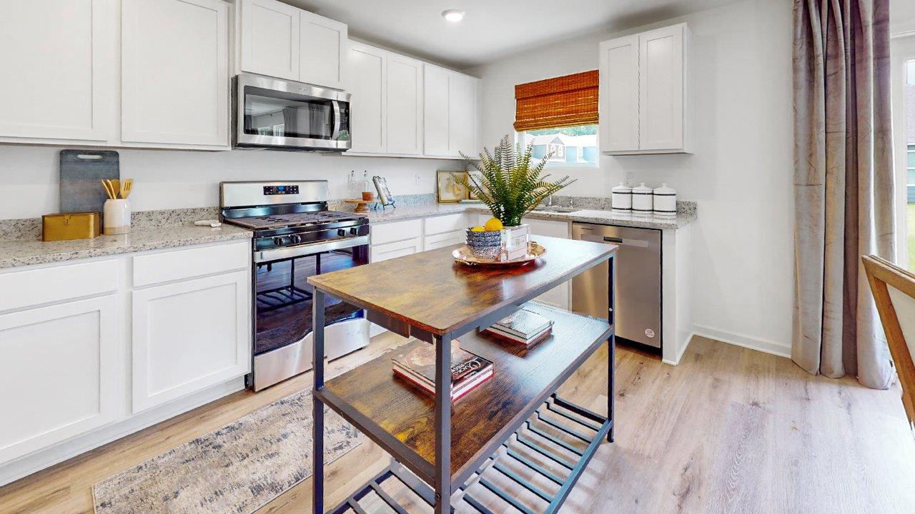 Kitchen with sleek white cabinets and modern stainless steel appliances