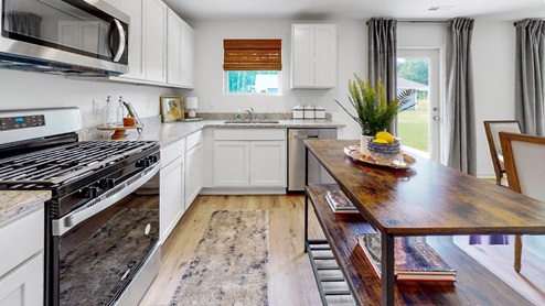 6.	Taylor – Kitchen – 2 – A kitchen with sleek white cabinets, modern stainless steel appliances, and a wooden kitchen shelf