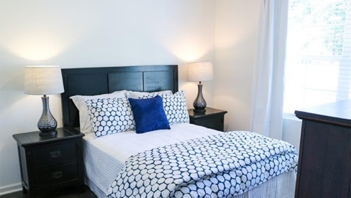 Cali – Bedroom 2- the second bedroom features a bed with 2 nightstands and a large window