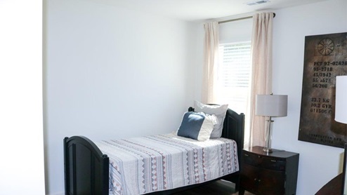 Cali – Bedroom 3 – the third bedroom is in the front of the house and features a bed with 2 nightstands and a dresser