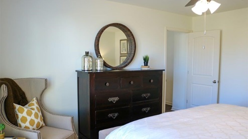 Cali – Primary bedroom – 2 – the large primary bedroom shows off ample space with a large king bed
