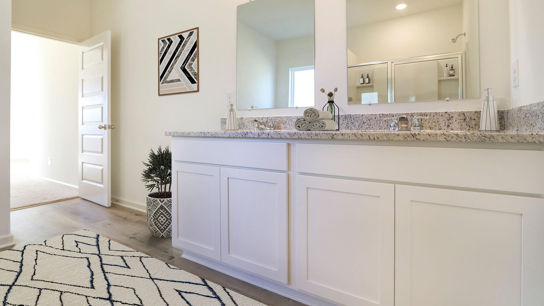 The bathroom has numerous cabinets and mirrors.