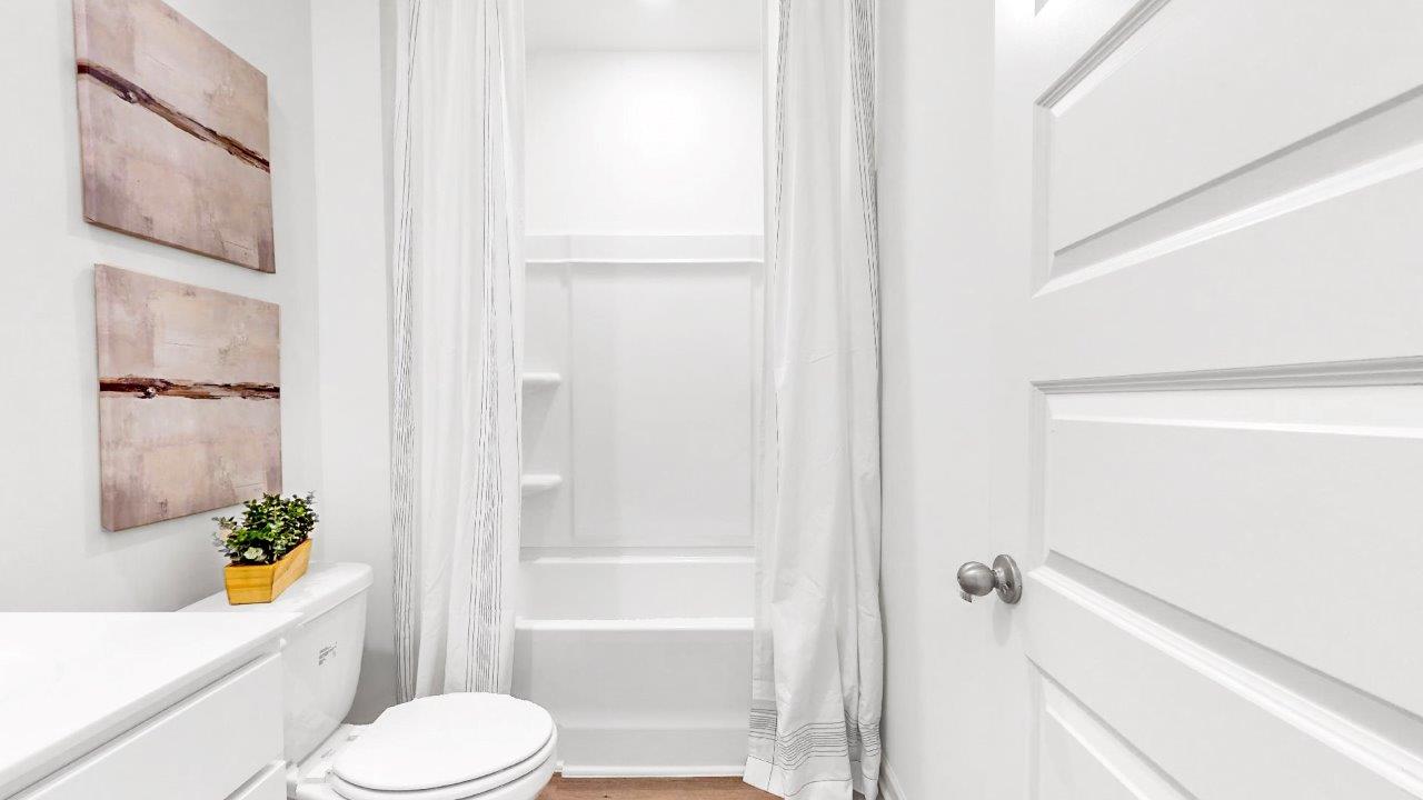 There is a full sized bathroom on the main level complete with vanity with one sink, toilet and a tub shower