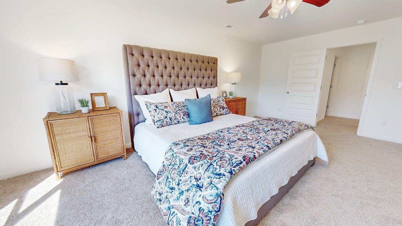 The second level expansive primary bedroom consists of a large king sized bed, 2 oversized night tables, a dresser and two large guest chairs