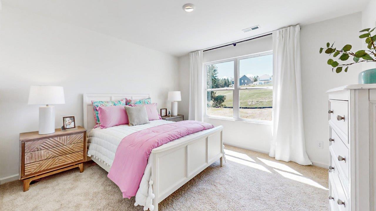 the second level fifth bedroom has a full bed with 2 nightstands