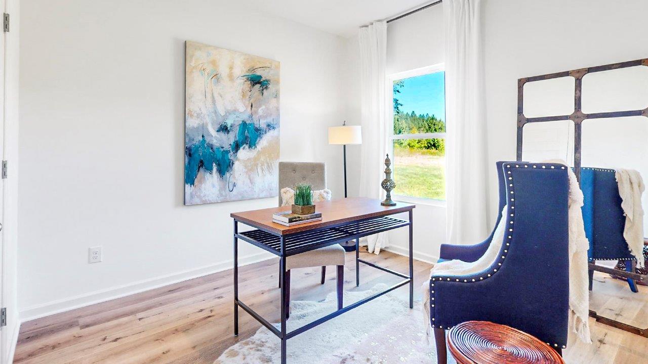 A bedroom is off the living room that is currently used as an office complete with desk and 2 guest chairs