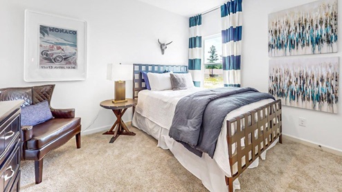 Destin – Bedroom 3 – the third bedroom features a large bed, nightstand, accent chair and dresser
