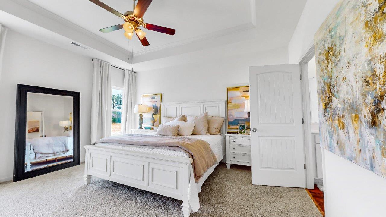 Destin – Primary Bedroom – the primary bedroom is very spacious with a large king sized bed, two nightstands, and trey ceilings