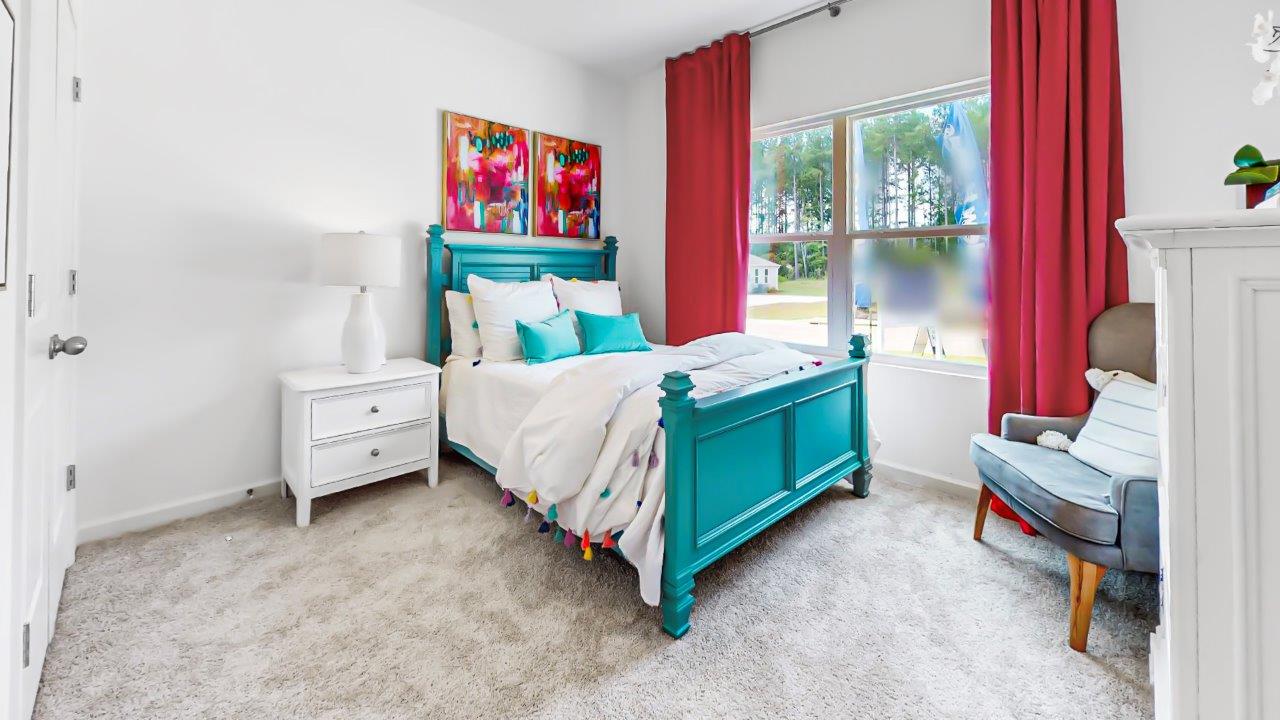 Destin – Bedroom 2 – the second bedroom which is in the front of the home features a bed, nightstand, accent chair and dresser