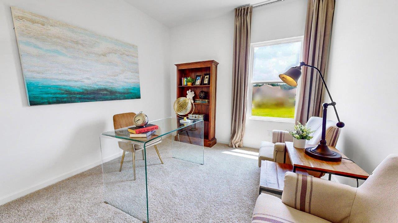 Fourth bedroom is currently being used as an office features a desk, bookshelf and two guest chairs split by a table