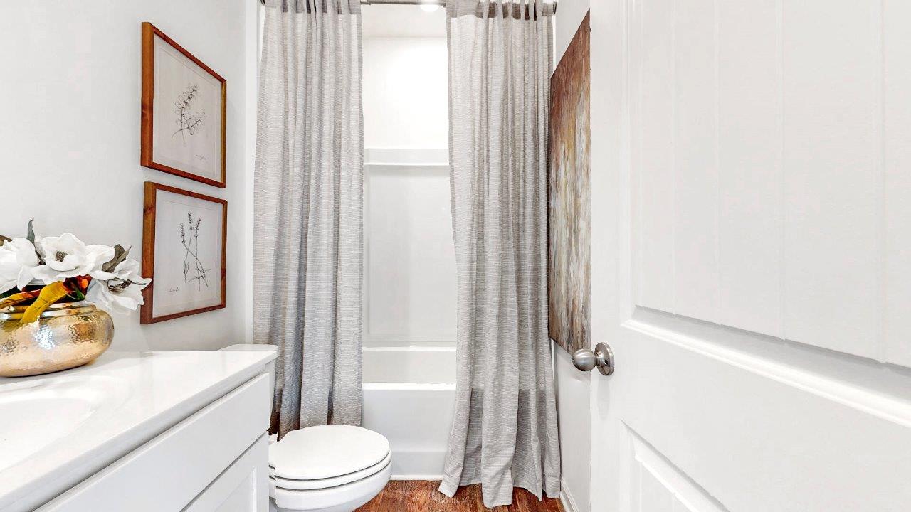 Destin – Bathroom 3 – the third bathroom features a vanity with single sink, tub shower nad a toilet