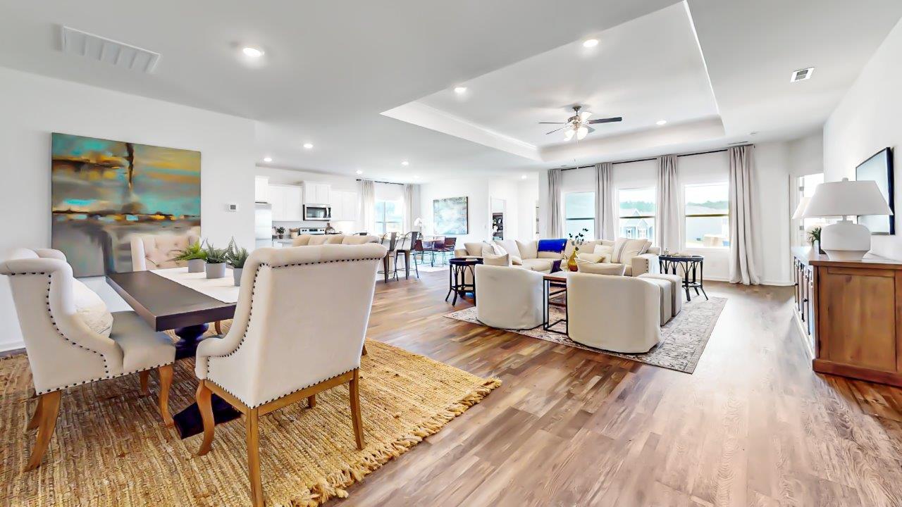 Open concept living room, formal dining room, kitchen and breakfast nook are shown with the trey ceilings