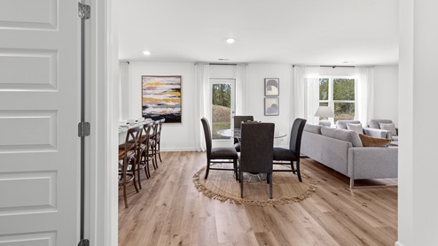 Penwell – Dining – Breakfast nook with a round dining table that opens to the kitchen and the living room