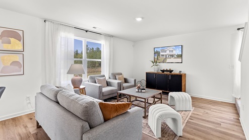 Penwell – Living Room – 1 - A well-designed living room with elegant hardwood floors and an open kitchen.
