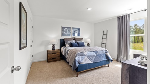 Penwell – Bedroom 2 – Spacious second bedroom with a bed, 2 nightstands, and chair and a dresser