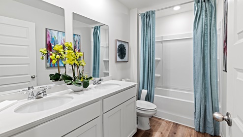 Penwell – Bathroom 2 – Bathroom with a double vanity, and tub/ shower