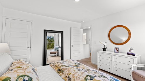 Penwell – Bedroom 2 – Spacious second bedroom with a bed, 2 nightstands, and chair and a dresser