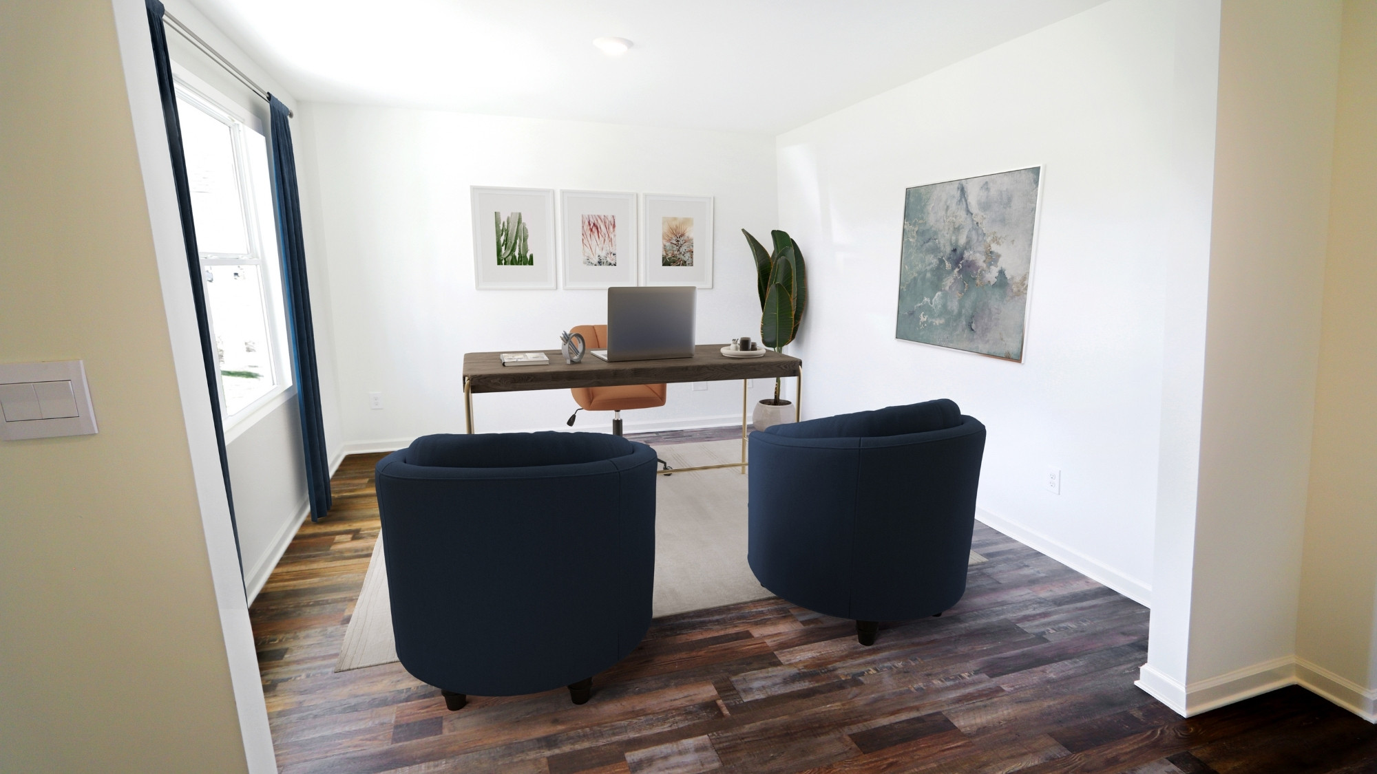 The first floor also features a spacious flex space, here shown staged as an office. A large window allows for lots of natural light to fill the space.