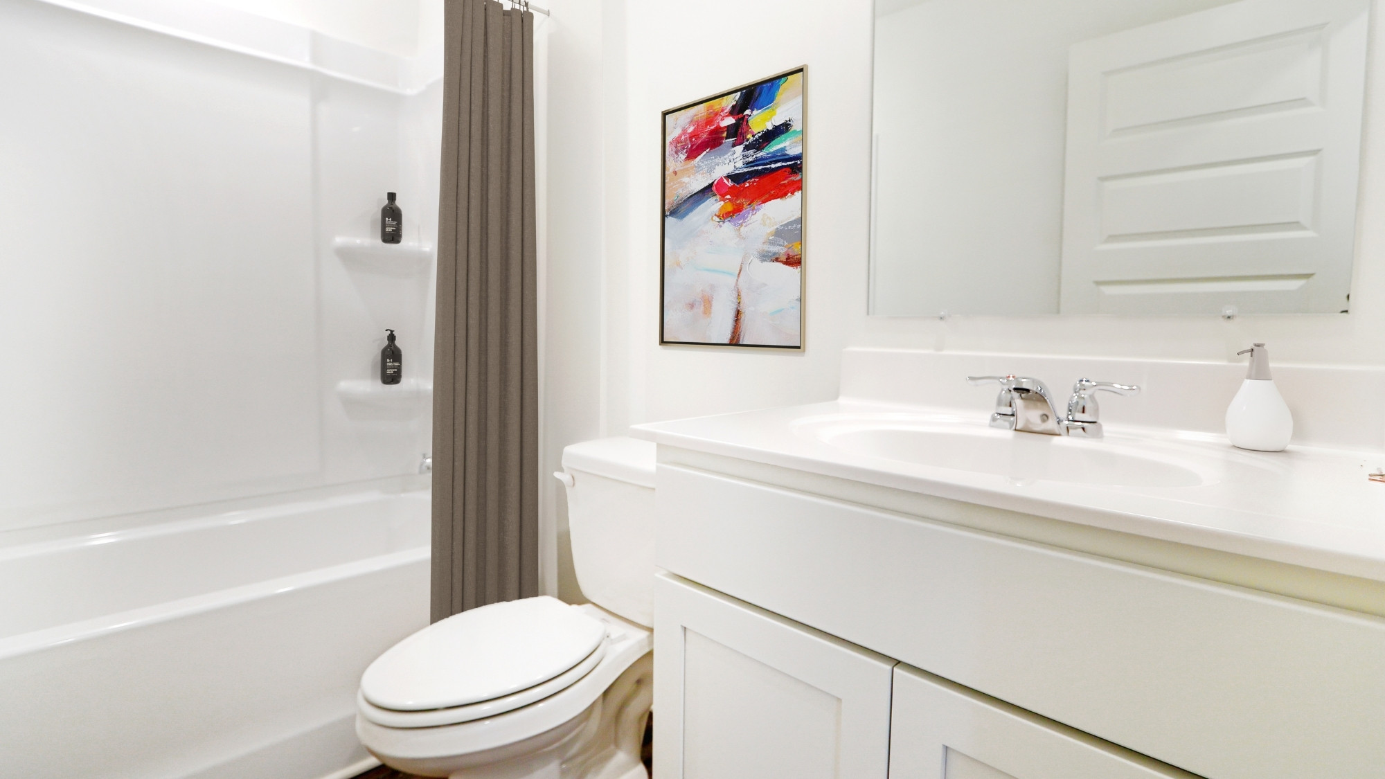 The downstairs bath features a shower/ tub combo and a spacious vanity.