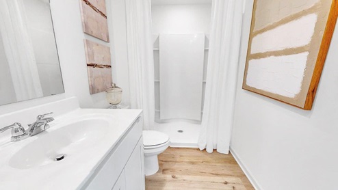 The bathroom features a spacious double vanity with mirrors.
