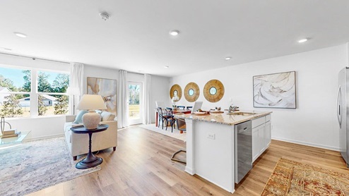 The dining area features a spacious kitchen table and six chairs, connecting seamlessly to the kitchen.