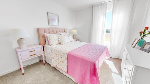 The second bedroom is equipped with two twin beds and a nightstand for convenience.