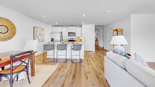 The dining room has an open concept design, connecting it to the kitchen and the living room.