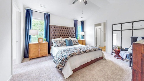 Elston – Primary Bedroom- Large primary bedroom with king sized bed, two oversized nightstands and a dresser