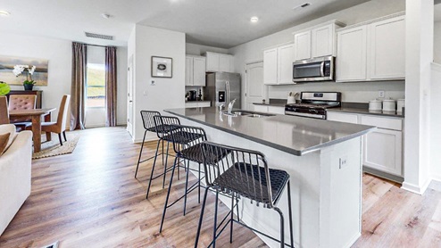 Elston – Kitchen – Open kitchen with a ktichen island, white cabinets and stainless steel appliance