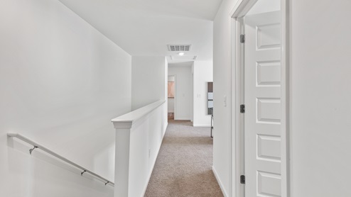 a view of the walk way to the bedrooms and loft living area