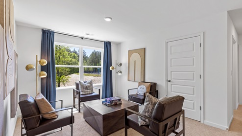 The loft style living room has space for a full set of living room furniture.