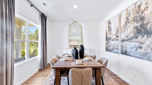 The formal dining room is furnished with a spacious dinner table and six chairs.