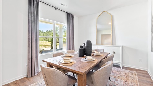 The formal dining room is furnished with a spacious dinner table and six chairs.
