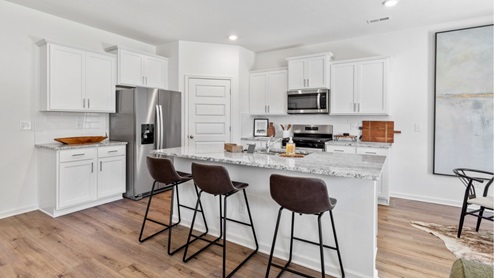 The kitchen features modern stainless steel appliances and ample counter space.