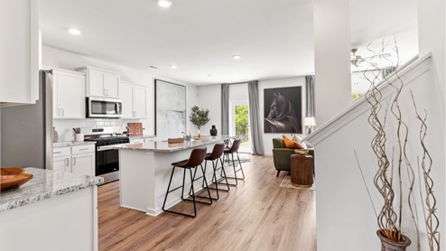 The kitchen features modern stainless steel appliances and ample counter space.