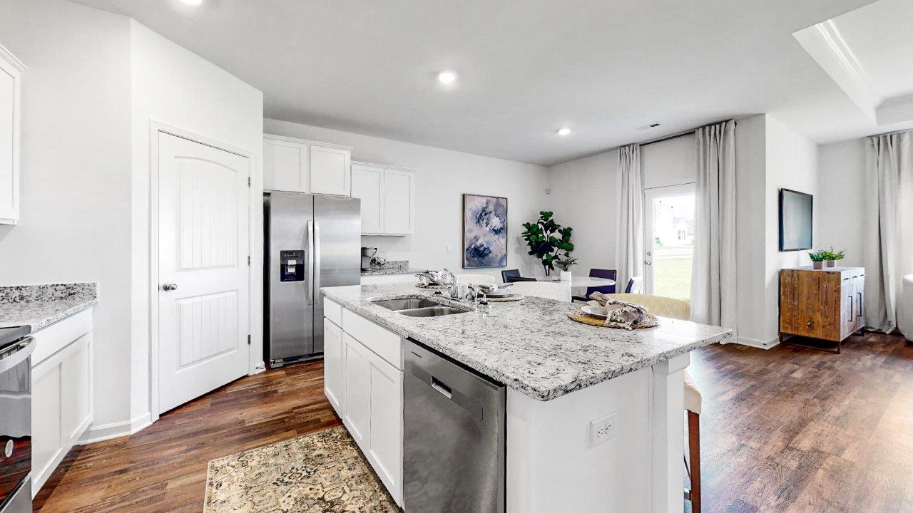 Rhett – Kitchen – 2 – A different view of the large kitchen that shows the large isalnd and stainless steel appliances