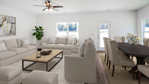 n open living area with light wood flooring, neutral-colored walls, and a ceiling fan with lights in the center of the room. The space is bright and airy, with natural light streaming in from large windows on one side. Multiple doors lead to other rooms, contributing to the open-concept layout that connects the living area seamlessly with the kitchen.