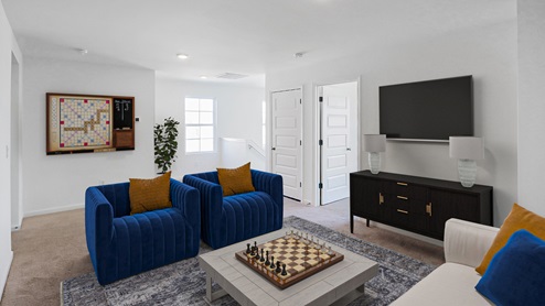 A spacious empty room featuring soft carpet flooring and clean white walls, creating a bright and airy atmosphere.