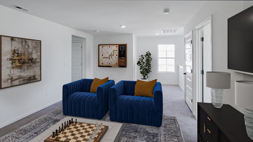 A spacious empty room featuring soft carpet flooring and clean white walls, creating a bright and airy atmosphere.