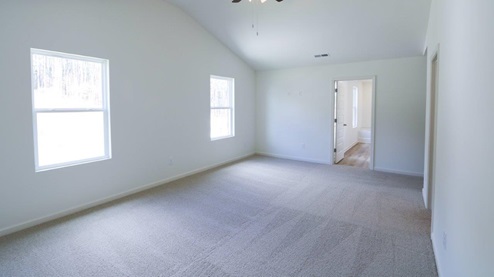 Bright and spacious room showcasing fresh carpet and natural light, perfect for your new home. MASTERBED_2- Bright and spacious bedroom featuring a ceiling fan and modern white walls, perfect for a cozy retreat.