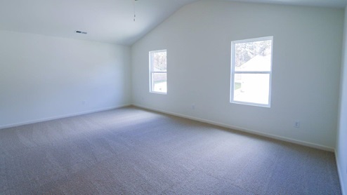Bright and spacious room showcasing fresh carpet and natural light, perfect for your new home. MASTERBED_2- Bright and spacious bedroom featuring a ceiling fan and modern white walls, perfect for a cozy retreat.