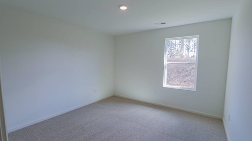 Bright and spacious bedroom with new carpeting and a scenic view outside. BEDROOM1- Bright and spacious room with fresh paint and soft carpeting, perfect for creating a cozy retreat.