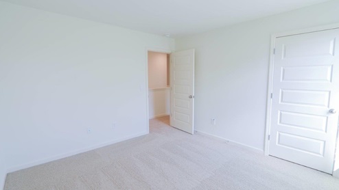 Bright and spacious bedroom with new carpeting and a scenic view outside. BEDROOM1- Bright and spacious room with fresh paint and soft carpeting, perfect for creating a cozy retreat.