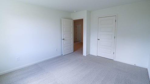 Bright and spacious vacant room with soft carpet, perfect for creating your dream bedroom or home office. BEDROOM2- Bright and airy empty room with a large window, perfect for new decor ideas and fresh living spaces.