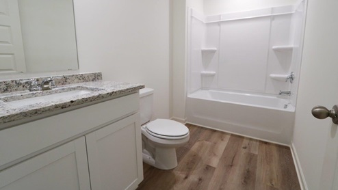 Modern and minimalist bathroom featuring a sleek bathtub and shower combination for a stylish and functional space. GUESTBATH_2- Explore this elegant bathroom sink with a stunning granite countertop, perfect for enhancing your home's style. GUESTBATH_3- Bright and modern bathroom featuring a sleek granite countertop and clean white fixtures for a fresh look. GUESTBATH_4- Modern bathroom design featuring a spacious layout with a stylish granite countertop and sleek bathtub, perfect for creating a relaxing space.