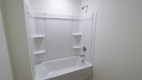 Modern and minimalist bathroom featuring a sleek bathtub and shower combination for a stylish and functional space. GUESTBATH_2- Explore this elegant bathroom sink with a stunning granite countertop, perfect for enhancing your home's style. GUESTBATH_3- Bright and modern bathroom featuring a sleek granite countertop and clean white fixtures for a fresh look. GUESTBATH_4- Modern bathroom design featuring a spacious layout with a stylish granite countertop and sleek bathtub, perfect for creating a relaxing space.