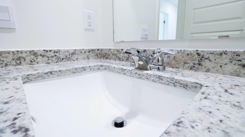 Modern and minimalist bathroom featuring a sleek bathtub and shower combination for a stylish and functional space. GUESTBATH_2- Explore this elegant bathroom sink with a stunning granite countertop, perfect for enhancing your home's style. GUESTBATH_3- Bright and modern bathroom featuring a sleek granite countertop and clean white fixtures for a fresh look. GUESTBATH_4- Modern bathroom design featuring a spacious layout with a stylish granite countertop and sleek bathtub, perfect for creating a relaxing space.