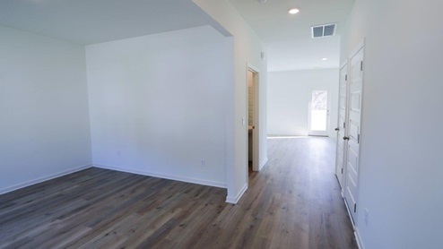 Bright and airy interior featuring modern finishes and spacious layout for a comfortable living experience. Bright and inviting hallway showcasing modern design with natural light and stylish doors.