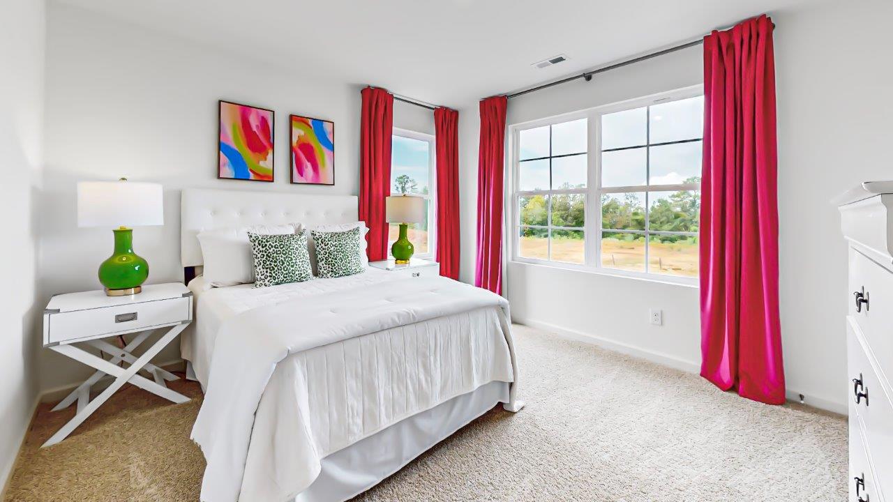 Second level fifth bedroom has a full bed with 2 nightstands