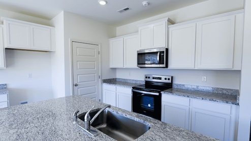 Bright and spacious kitchen featuring modern appliances and ample countertop space, perfect for cooking and entertaining. The kitchen is bright and spacious, with plenty of natural light and room to move around. It is equipped with modern appliances, making meal preparation convenient and efficient. There is ample countertop space, providing plenty of room for cooking and food preparation. This kitchen is perfect for both cooking and entertainment, with its inviting layout and functionality.
